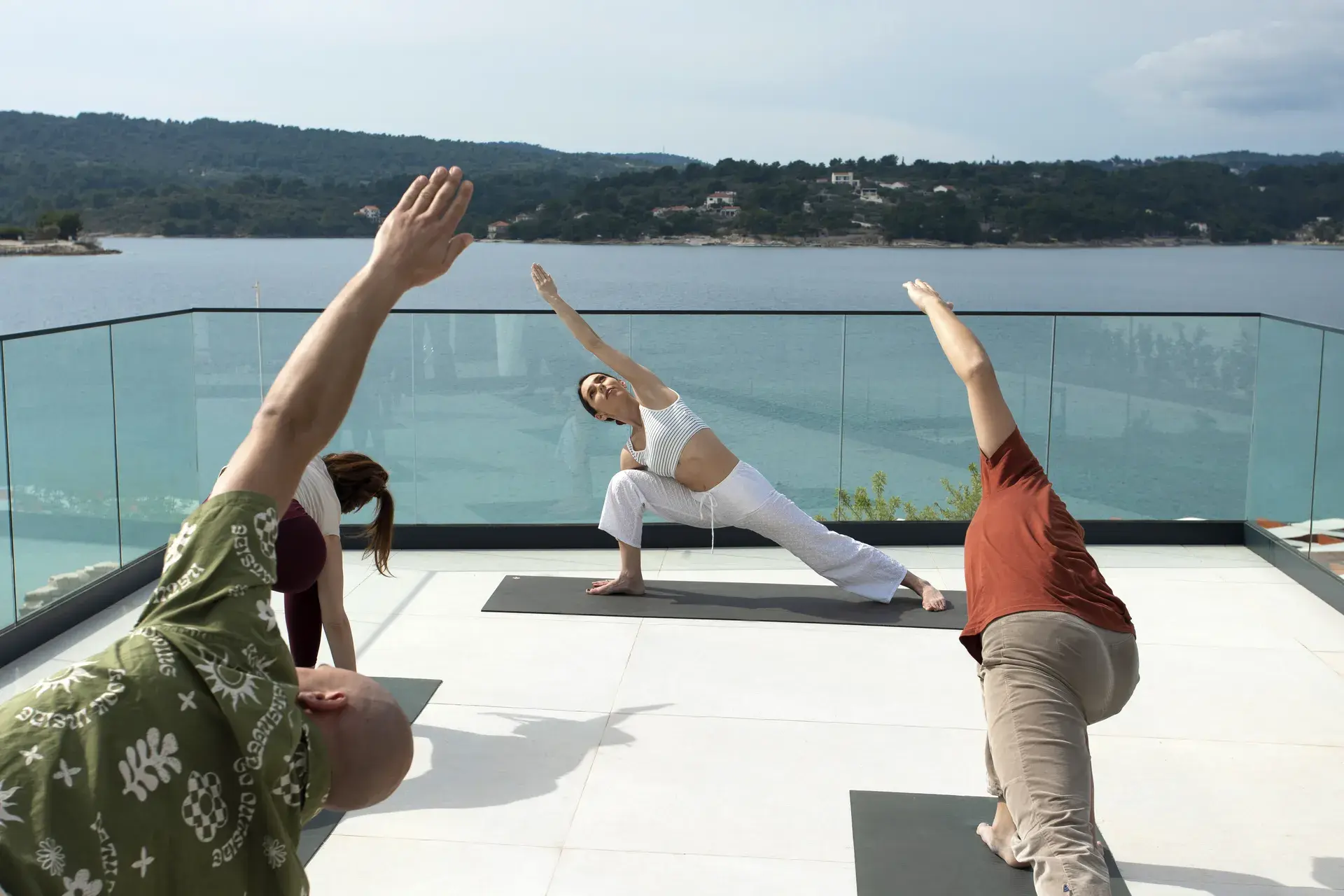 Warrior pose in open-air retreat setting